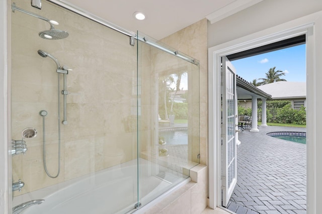 bathroom with shower / bath combination with glass door