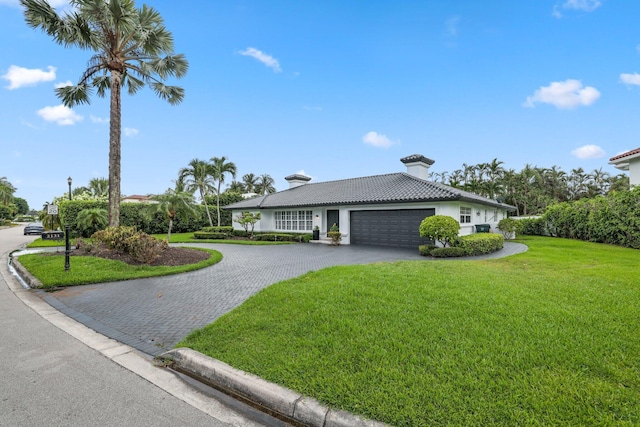 view of front of home featuring a front yard and a garage