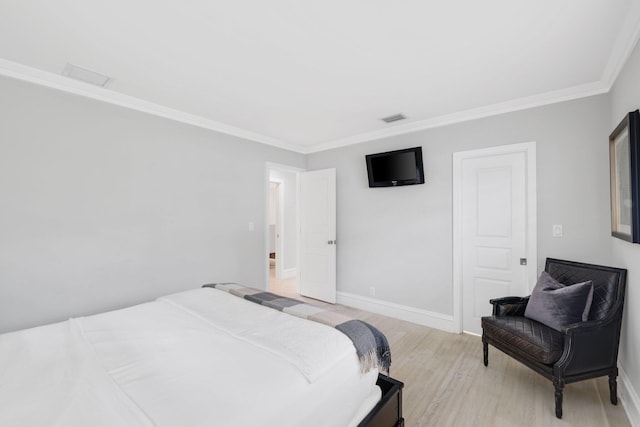 bedroom featuring crown molding and light hardwood / wood-style flooring