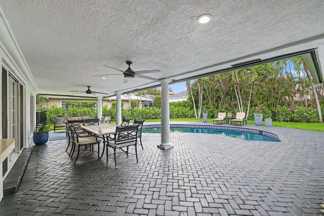 view of swimming pool with an outdoor living space, a patio, and ceiling fan