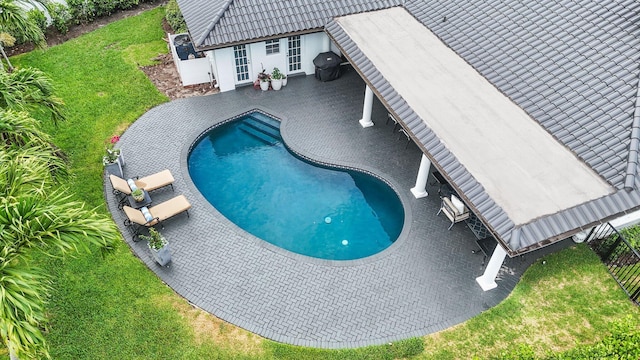 view of swimming pool with a yard and a patio area