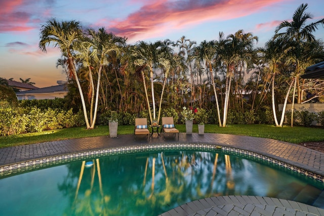 view of pool at dusk