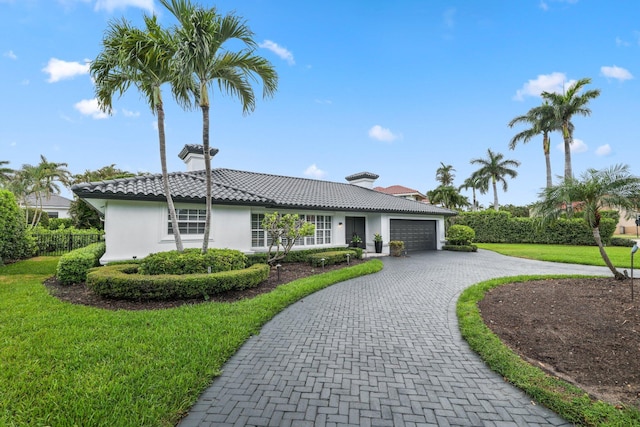 view of front facade featuring a garage and a front lawn