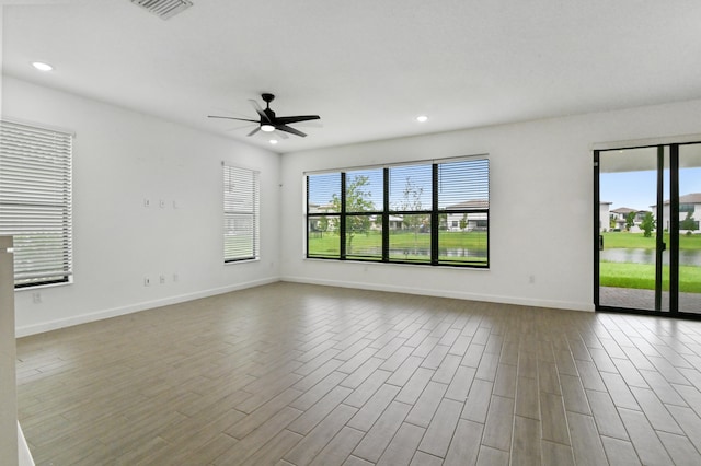 spare room with light hardwood / wood-style floors and ceiling fan