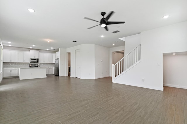 unfurnished living room featuring light hardwood / wood-style flooring and ceiling fan