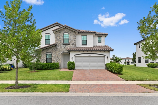 mediterranean / spanish-style home featuring a garage and a front lawn