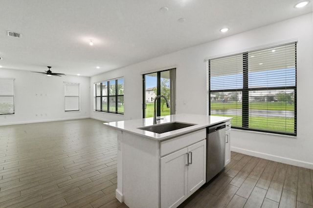 kitchen featuring sink, stainless steel dishwasher, a center island with sink, white cabinetry, and dark hardwood / wood-style floors