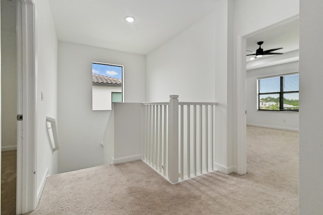 hallway with light colored carpet