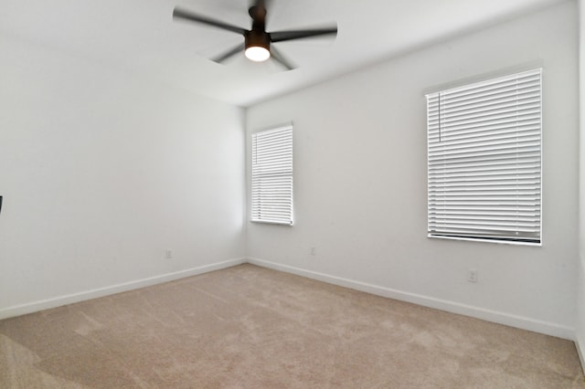 empty room with ceiling fan and light colored carpet