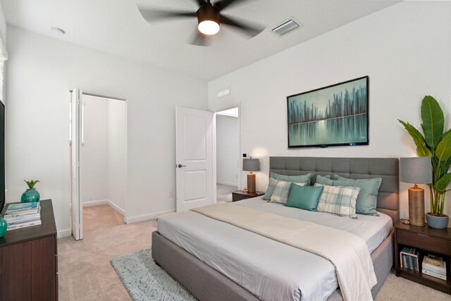 bedroom with ceiling fan and light colored carpet