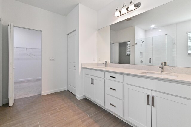 bathroom with vanity and a shower with shower door