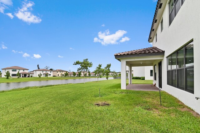 view of yard featuring a patio and a water view