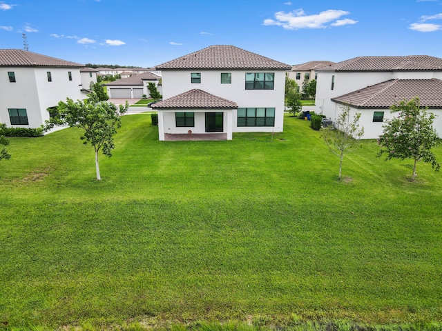 back of property featuring a lawn