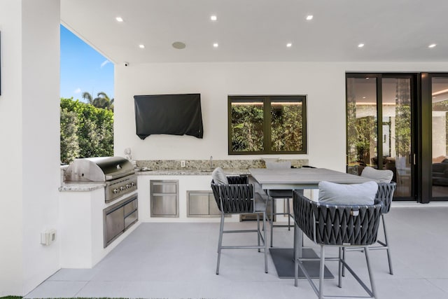 view of patio / terrace with an outdoor kitchen, area for grilling, and sink