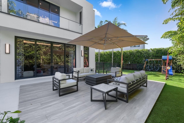 view of patio with an outdoor living space and a playground