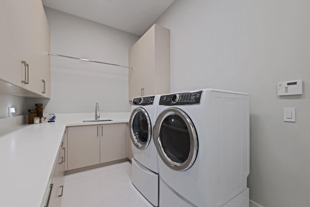 washroom featuring washer and clothes dryer, cabinets, and sink