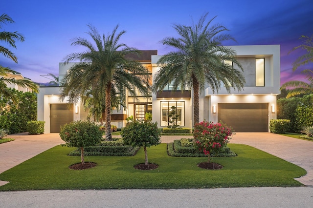 view of front facade with a garage and a yard