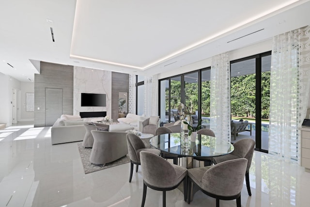 dining room featuring light tile patterned floors, tile walls, and french doors