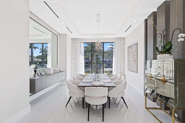 dining room with a tray ceiling, a wealth of natural light, and an inviting chandelier