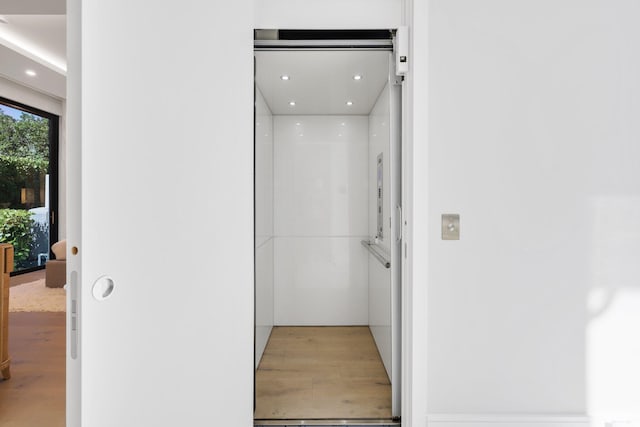 bathroom featuring wood-type flooring and elevator