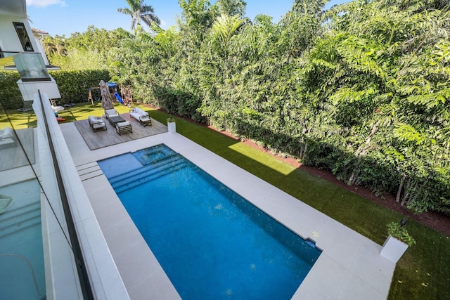 view of swimming pool featuring outdoor lounge area and a playground