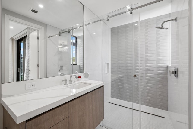 bathroom with vanity, walk in shower, and a wealth of natural light