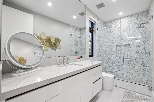 bathroom featuring walk in shower, vanity, toilet, and tile walls