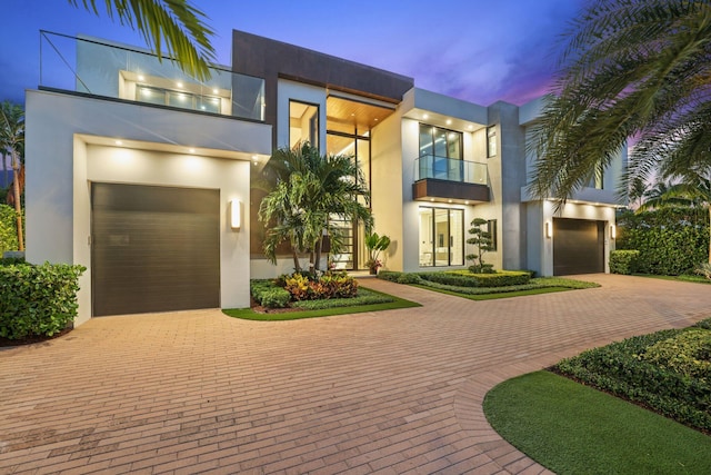 contemporary house with a garage and a balcony