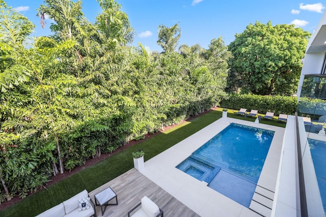 view of pool with an in ground hot tub