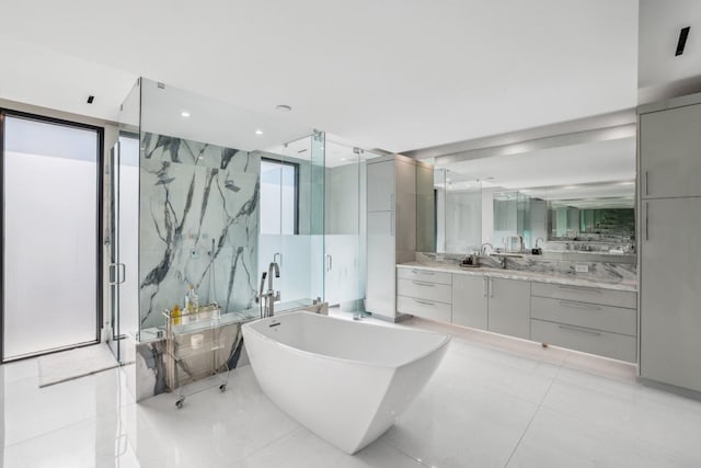 bathroom with tile patterned flooring, vanity, a healthy amount of sunlight, and independent shower and bath