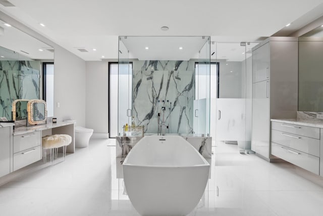 full bathroom featuring vanity, separate shower and tub, toilet, and floor to ceiling windows