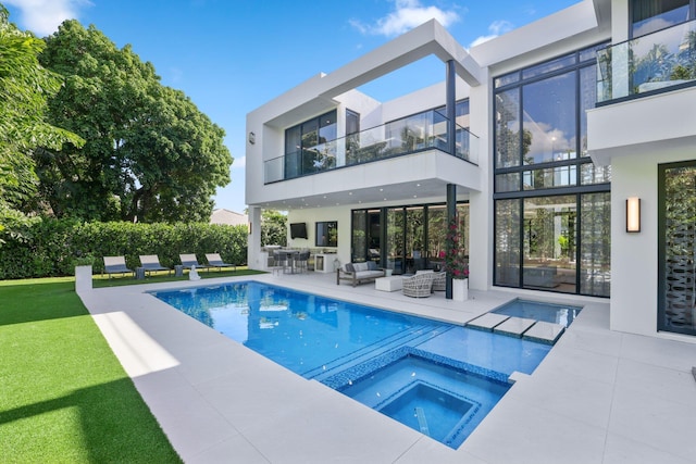 view of pool with an in ground hot tub, an outdoor living space, and a patio