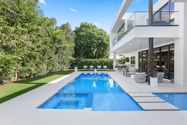 view of swimming pool featuring a patio area