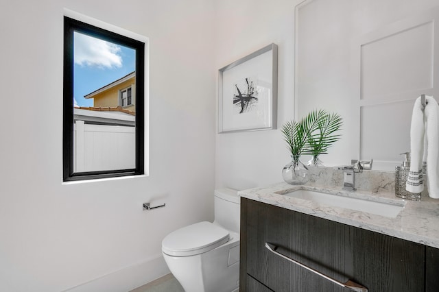 bathroom featuring toilet and vanity with extensive cabinet space