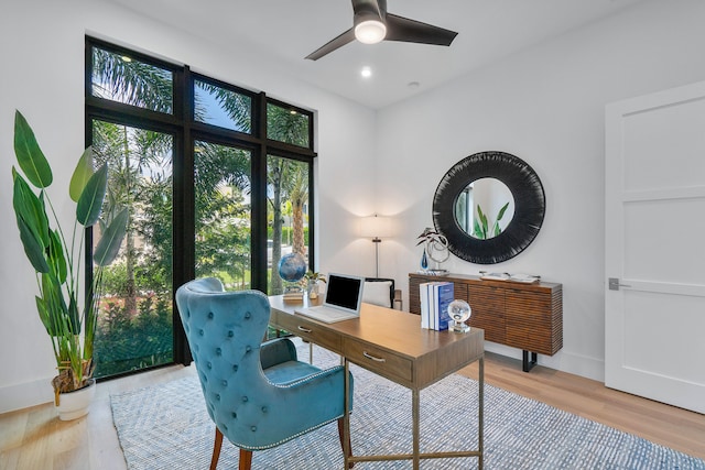 office with ceiling fan and light hardwood / wood-style flooring