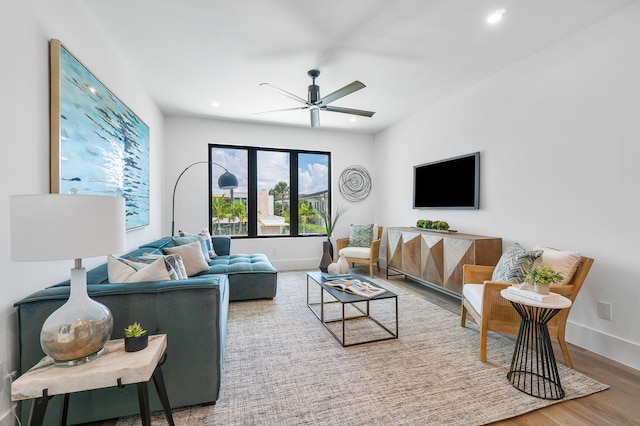 living room with ceiling fan and hardwood / wood-style flooring