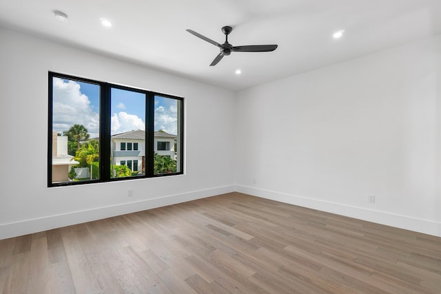 unfurnished room featuring ceiling fan and light wood-type flooring