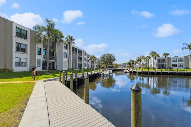 view of dock featuring a water view and a residential view