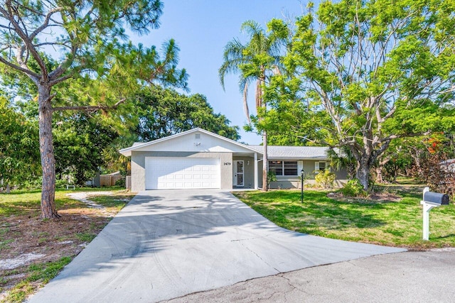 ranch-style house with a garage and a front lawn