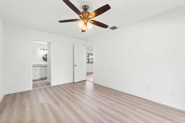 unfurnished bedroom with ensuite bathroom, ceiling fan, and light hardwood / wood-style flooring