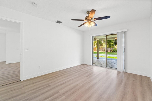 spare room featuring ceiling fan, a textured ceiling, and light hardwood / wood-style flooring