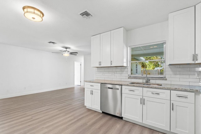 kitchen with white cabinetry, light hardwood / wood-style flooring, stainless steel dishwasher, and sink