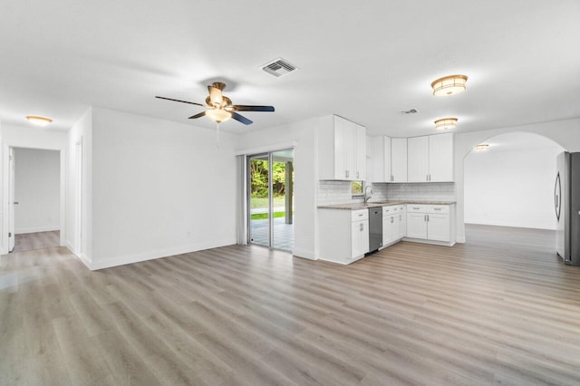 kitchen with light wood-type flooring, white cabinetry, sink, and appliances with stainless steel finishes