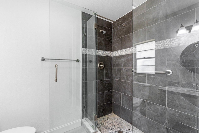 bathroom featuring an enclosed shower and toilet