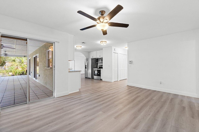 unfurnished living room with ceiling fan and light hardwood / wood-style floors