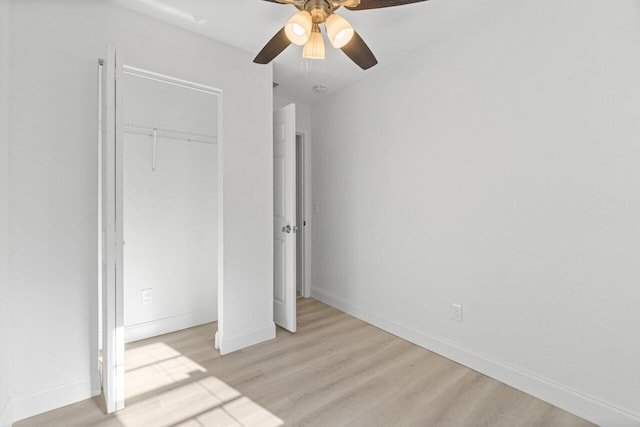 unfurnished bedroom featuring ceiling fan, a closet, and light hardwood / wood-style floors