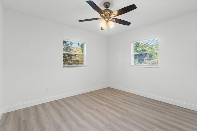 empty room with ceiling fan and light wood-type flooring