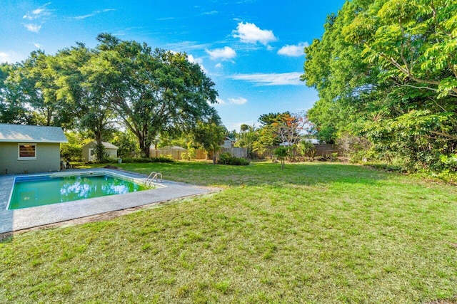 view of swimming pool featuring a lawn