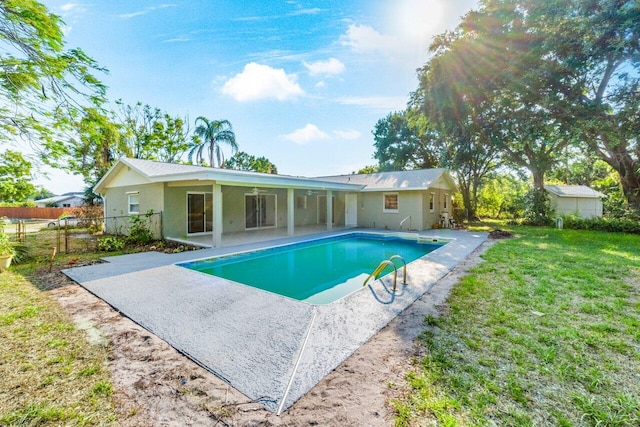 view of swimming pool with a lawn and a patio area