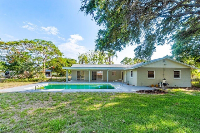 back of house featuring a lawn and a patio area